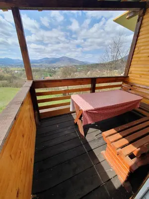 a picnic table on the deck of a cabin at Blanca 6 in Nova Bila