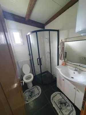 a bathroom with a shower and a toilet and a sink at Blanca 6 in Nova Bila