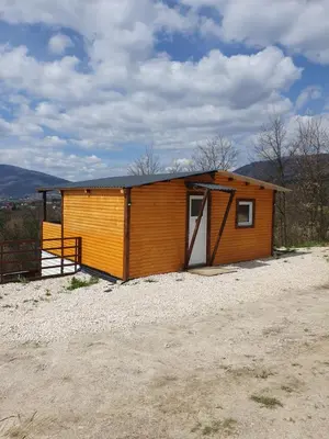 a small shed with a door on a dirt road at Blanca 6 in Nova Bila