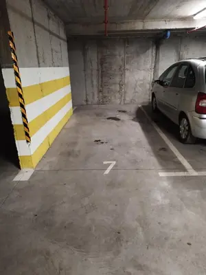 a parking garage with a car parked in it at Stan na dan Apartman Harmonija in Zalužani