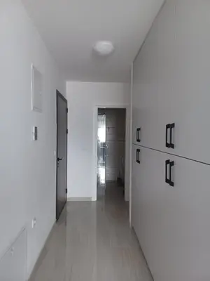 an empty hallway with white walls and wooden floors at Hilandar in Teslić