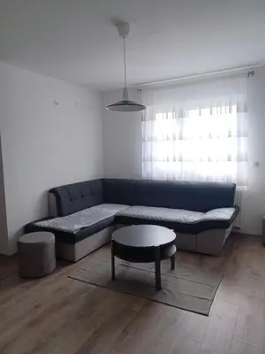 a living room with a blue couch and a table at Hilandar in Teslić
