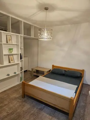 a bedroom with a bed and a chandelier at K&N centar Doboj in Doboj