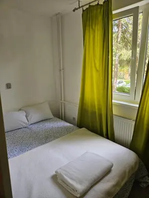 a bedroom with two beds and a window at K&N centar Doboj in Doboj