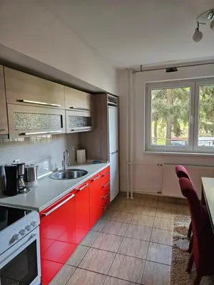 a kitchen with red cabinets and a sink at K&N centar Doboj in Doboj