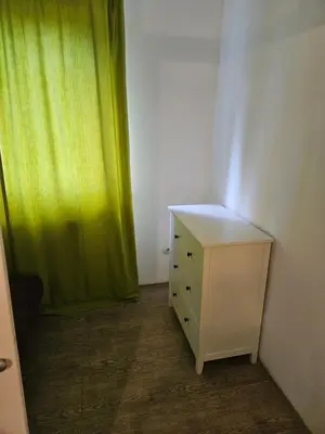 a room with a dresser and a green curtain at K&N centar Doboj in Doboj