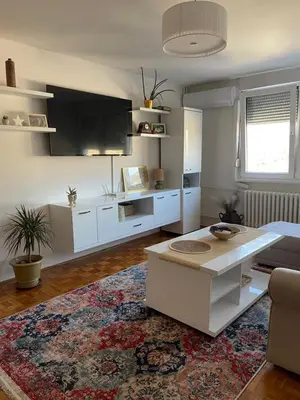 a living room with a table and a couch at Bambi Zenica in Zenica