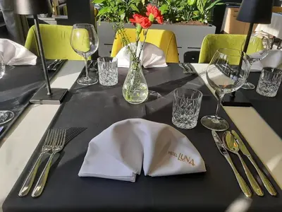 a table with a white napkin on top of a table at Hotel Luna Bihać in Bihać
