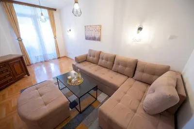 a living room with a couch and a table at Apartman Magija in Banja Luka