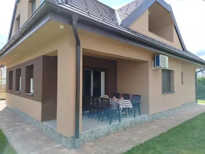a house with a patio with a table and chairs at Villa Orhan in Bihać