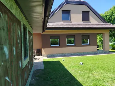a house with two soccer balls in the yard at Villa Orhan in Bihać