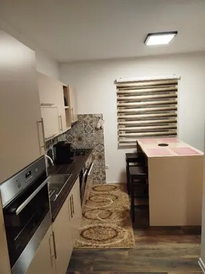 a kitchen with a table and a counter top at Villa Orhan in Bihać