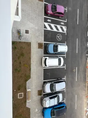 an overhead view of cars parked in a parking lot at Apartman ADA in Železnička Stanica Incel
