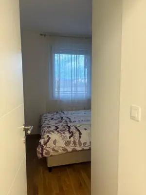 a bedroom with a bed and a window at Apartman ADA in Železnička Stanica Incel