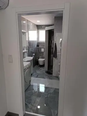 a bathroom with a toilet and a sink at Apartman Zana in Visoko