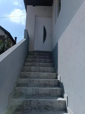 a stairway leading up to a white door at Apartman Zana in Visoko