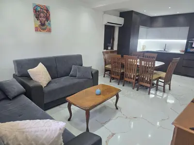 a living room with a couch and a table at Apartmani Mikić in Bosanski Šamac