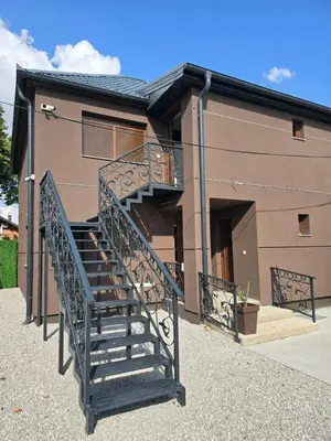 a spiral staircase in front of a house at Apartmani Mikić in Bosanski Šamac