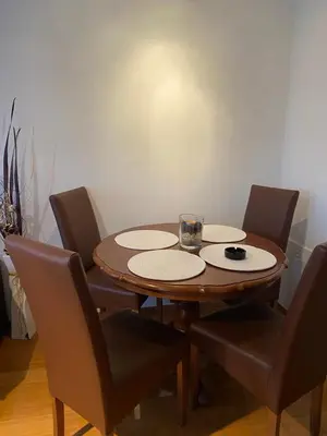 a wooden table with four chairs and a glass at Apartman Nasic in Bihać