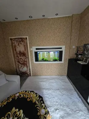 a living room with a large window in the wall at KONAK kod ODISEJE in Tuzla