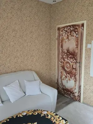 a living room with a couch and a wall at KONAK kod ODISEJE in Tuzla