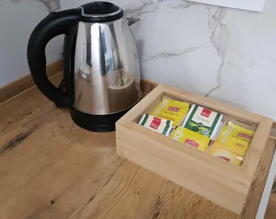 a coffee pot sitting on a table next to a wooden box at Elena - stan na dan in Banja Luka