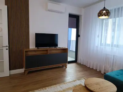 a living room with a flat screen tv on a entertainment center at Elena - stan na dan in Banja Luka