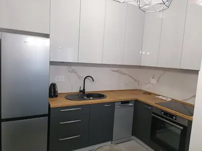 a kitchen with white cabinets and a sink at Elena - stan na dan in Banja Luka