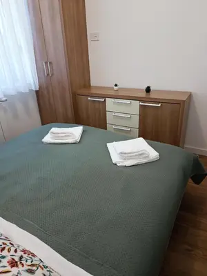 a bedroom with a bed with two white towels on it at Elena - stan na dan in Banja Luka