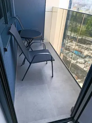 a balcony with two chairs and a table at Elena - stan na dan in Banja Luka