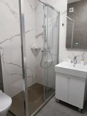 a bathroom with a shower and a toilet and a sink at Elena - stan na dan in Banja Luka