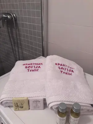 a pile of towels sitting on a counter in a bathroom at Apartman Sofija centar in Teslić