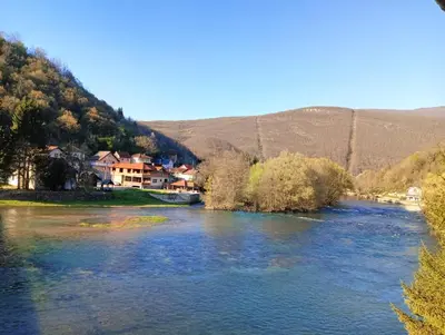 a view of a river with houses and a town at Vila Medo in Kulen Vakuf