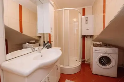 a bathroom with a sink and a washing machine at Apartman Eni in Livno