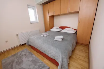 a bedroom with a bed with two towels on it at Apartman Eni in Livno