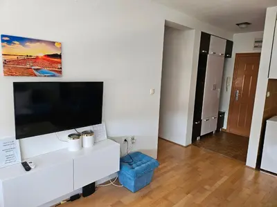 a living room with a large flat screen tv on a wall at Apartman Dona in Bosanska Gradiška