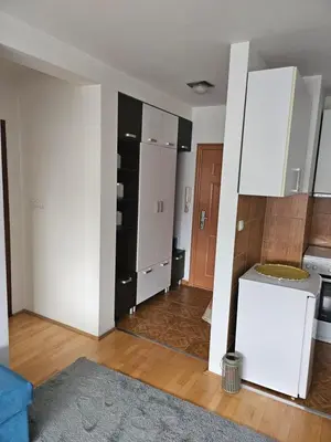 a room with a kitchen with white cabinets at Apartman Dona in Bosanska Gradiška
