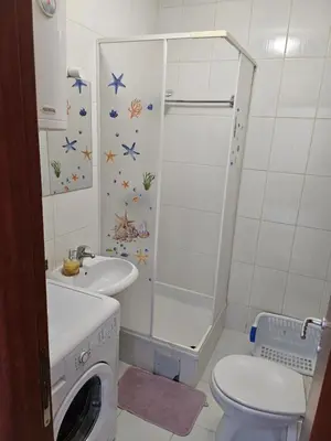 a bathroom with a shower and a toilet and a sink at Apartman Dona in Bosanska Gradiška