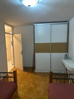 an empty room with a glass partition and a door at Stan in Zenica