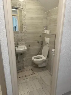 a bathroom with a toilet and a sink at Stan in Zenica