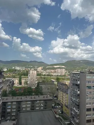a view of a city with buildings and mountains at Stan in Zenica