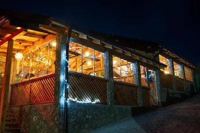 a building with a lot of windows at night at EJDE RESORT Šiljkovača in Velika Kladuša