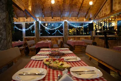 a dining room with a table with food on it at EJDE RESORT Šiljkovača in Velika Kladuša