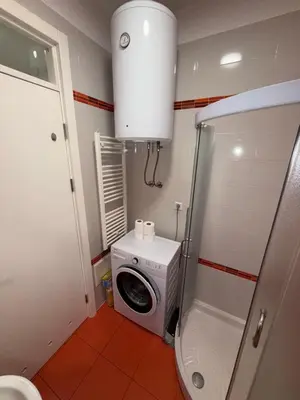 a bathroom with a washing machine and a washer at San apartment in Banja Luka