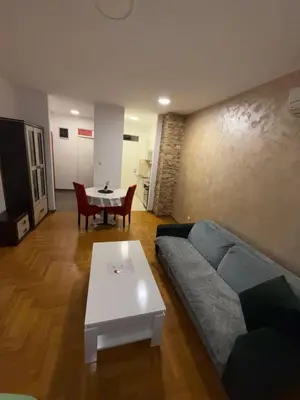 a living room with a couch and a table at San apartment in Banja Luka