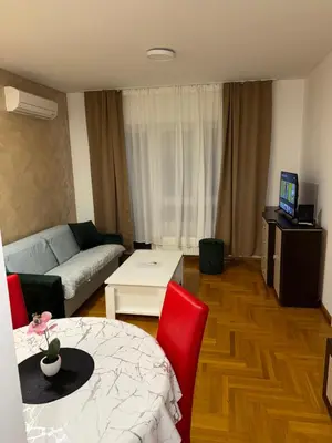 a living room with a couch and a table at San apartment in Banja Luka
