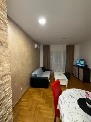 a living room with a bed and a couch at San apartment in Banja Luka