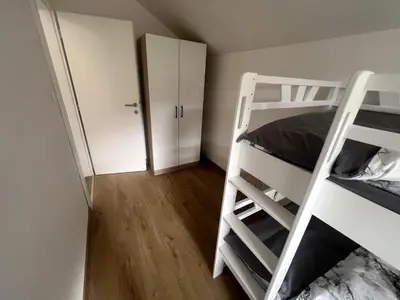 a bedroom with two bunk beds and a closet at Stone House Ripac in Bihać