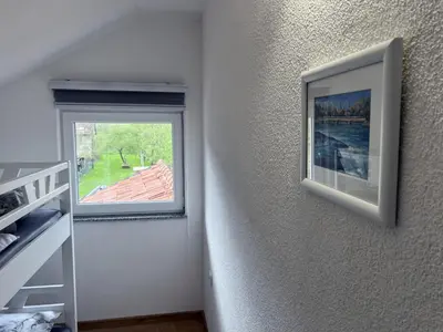 a room with a window and a picture on the wall at Stone House Ripac in Bihać
