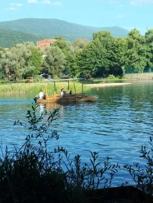 two people in a boat on a lake at Stone House Ripac in Bihać